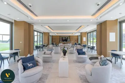 a lobby with white couches and tables and windows at Vogue Downtown Views II with Direct Access to Dubai Mall Via a Climate Controlled Bridge, Two Bedroom Apartment with Balcony and Burj Khalifa View in Dubai