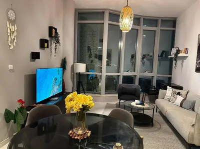 a living room with a couch and a glass table at Cozy 1BHK Apartment-Dubai Marina in Dubai