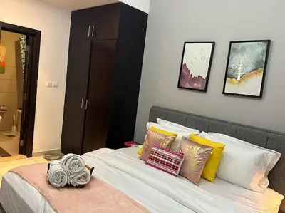 a bedroom with a bed with pillows on it at Cozy 1BHK Apartment-Dubai Marina in Dubai
