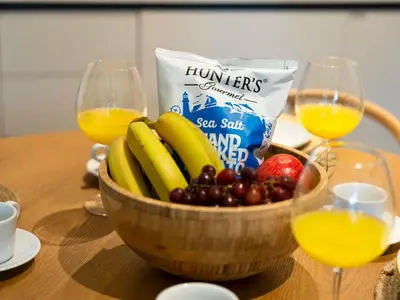 a bowl of fruit and two glasses of orange juice at Chic 1 Bedroom on Private Beach in Dubai Harbour in Dubai