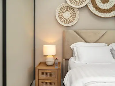 a bedroom with two beds and a lamp on a night stand at Chic 1 Bedroom on Private Beach in Dubai Harbour in Dubai