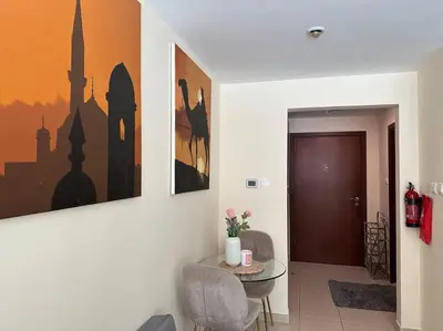a living room with a table and a door at Luxury Studio Near Burj Khalifa in Dubai