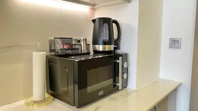 a coffee maker sitting on top of a microwave at Luxury Interior Studio with Direct Burj Khalifa Views in the Heart of Dubai in Dubai