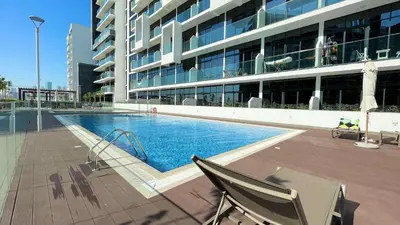 a swimming pool with a slide in a building at Luxury Interior Studio with Direct Burj Khalifa Views in the Heart of Dubai in Dubai