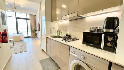 a kitchen with a sink and a microwave at Luxury Interior Studio with Direct Burj Khalifa Views in the Heart of Dubai in Dubai