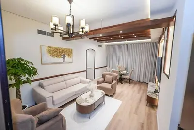 a living room with a couch and a table at The Nest by Beds & Company in Dubai