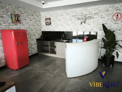 a kitchen with a red refrigerator and a counter at La Riviera Serenity in Dubai