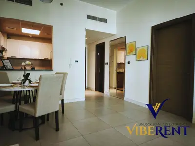 a kitchen and dining room with a table and chairs at La Riviera Serenity in Dubai