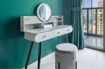a dressing table with a mirror and a stool at Stunning Burj Khalifa View 5 Star Hotel Amenities in Dubai
