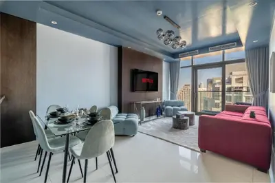a living room with a dining table and a couch at Stunning Burj Khalifa View 5 Star Hotel Amenities in Dubai