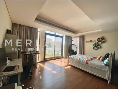 a bedroom with a bed and a desk and a window at Luxurious Meydan Dubai Villa with Unparalleled Views in Dubai