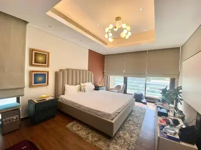 a bedroom with a large bed and a chandelier at Luxurious Meydan Dubai Villa with Unparalleled Views in Dubai