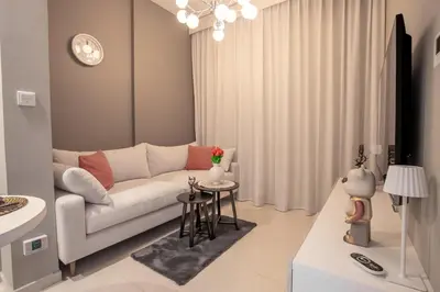 a living room with a white couch and a table at Dubai Burj KHALIFA VIEW SMART HOME ZADA TOWER in Dubai