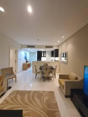 a living room with a couch and a dining room at damac maison canal view Luxuary 1BHK in heart downtow in Dubai