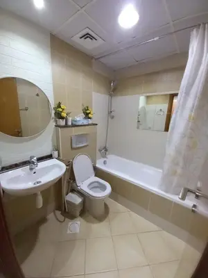 a bathroom with a toilet and a sink and a tub at Cosy Studio Marina in Dubai