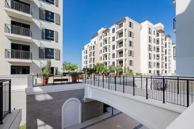 a balcony in a apartment with two tall buildings at La Mer 1bedroom Private Beach in Dubai