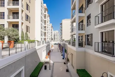 an empty corridor of a building with buildings at La Mer 1bedroom Private Beach in Dubai