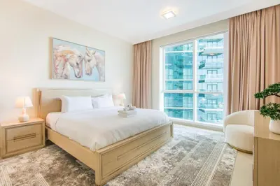 a bedroom with a bed and a large window at Al Bateen Residences, JBR- Stunning 2-BR Apartment with Sea View in Dubai