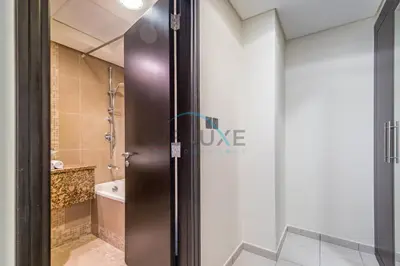 a door to a bathroom with a shower at Stylish 2BR in Sky Gardens, DIFC by Deluxe Holiday Homes in Dubai