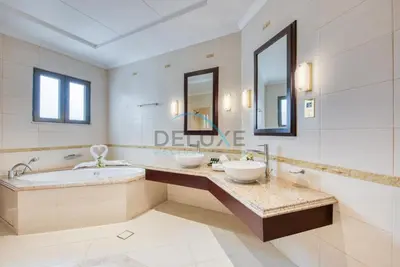 a bathroom with two sinks and a tub at Immaculate 4BR Villa with Assistant Room and Private Pool at Frond O Palm Jumeirah by Deluxe Holiday Homes in Dubai