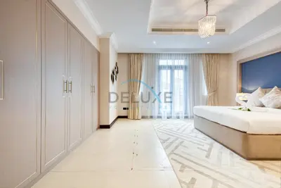 a bedroom with a large bed and a large window at Immaculate 4BR Villa with Assistant Room and Private Pool at Frond O Palm Jumeirah by Deluxe Holiday Homes in Dubai