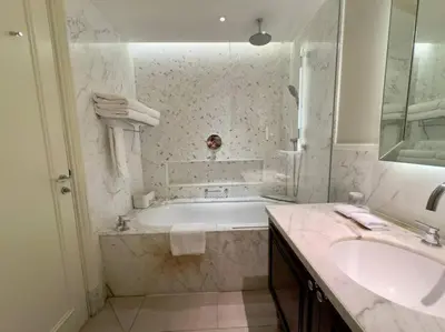 a white bathroom with a tub and a sink at ElevenSisters in Dubai