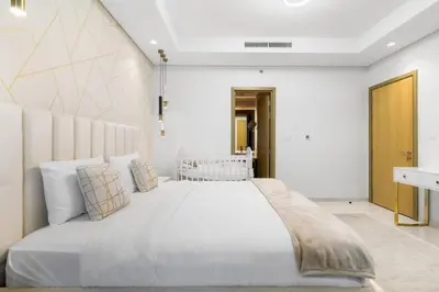 a bedroom with a large white bed with pillows at Spectacular 2 Bed Downtown I Highest Infiniti Pool in Dubai