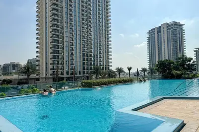 a large swimming pool in a city with tall buildings at Luxe Living in 1 Bedroom apartment at 17 Icon Bay in Dubai