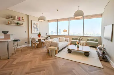 a living room with a couch and a table at Casa Bouclé An Urban sanctuary in DIFC 1BR in Dubai