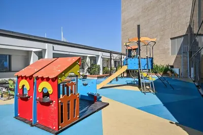 a playground with a slide and a play structure at Casa Bouclé An Urban sanctuary in DIFC 1BR in Dubai