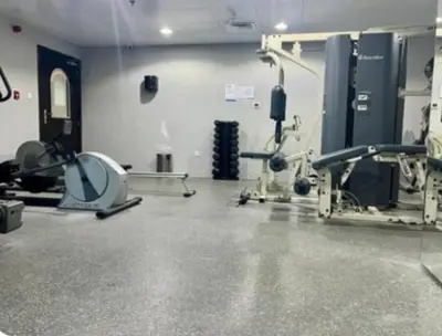 a gym with treadmills and machines in a room at White Sage Renovated Studio Nxt to Metro in Dubai