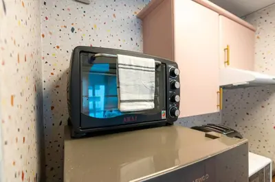 a tv sitting on top of a counter in a kitchen at White Sage Renovated Studio Nxt to Metro in Dubai