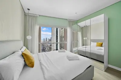 a bedroom with two beds and a large window at Spacious 1 BHK in Marina Heights in Dubai