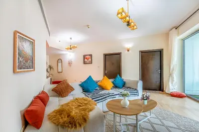 a living room with a couch and a table at Luxurious 2BR in Dubai Marina next to metro in Dubai