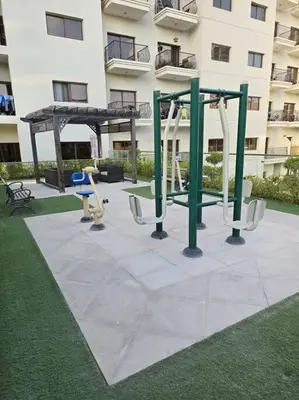 a playground in front of a building at Modern Studio Apartment in JVC, behind Circle Mall in Dubai