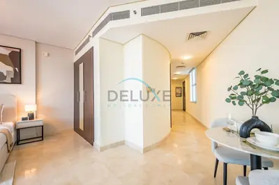 a room with a dining table and a door to a bedroom at Lively Studio in Sky Gardens, DIFC by Deluxe Holiday Homes in Dubai