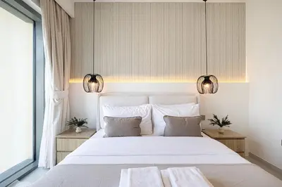 a bedroom with a large white bed with two lamps at BURJ ROYALE - Luxurious Two-Bedroom apartment in DOWNTOWN, Burj Khalifa view POOL in the building, 5-min walk to Dubai Mall & Dubai Fountains in Dubai