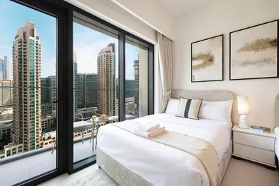 a bedroom with a bed and a large window at BURJ ROYALE - Luxurious Two-Bedroom apartment in DOWNTOWN, Burj Khalifa view POOL in the building, 5-min walk to Dubai Mall & Dubai Fountains in Dubai