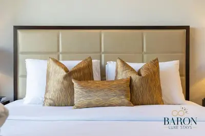 a bed with a bunch of pillows on it at The Modern in Dubai