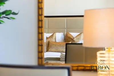 a mirror reflection of a couch in a bedroom at The Modern in Dubai