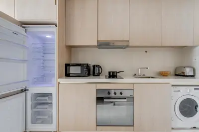 a kitchen with a stove and a microwave at Luxury Palm Tower Studio Apartments with Pool and Fantastic Sea View in Dubai