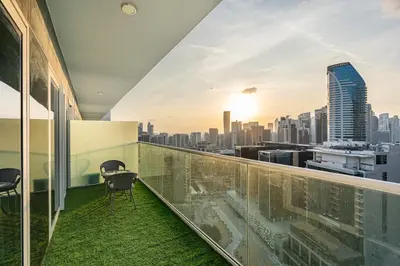 a balcony with chairs and a view of the city at Amazing 1BR APT with Burj Khalifa Views in Dubai