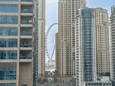 a city with tall buildings and a ferris wheel at Near Metro & Tram 2bed Dubai Marina Close To Jbr! in Dubai