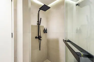 a shower with a shower head in a bathroom at Upgraded 1BR Retreat with Iconic Burj Khalifa Views in Dubai