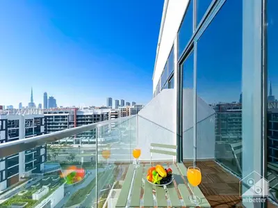 a balcony with a table and a view of a city at Bright Studio in Azizi Riviera Perfect City Escape in Dubai
