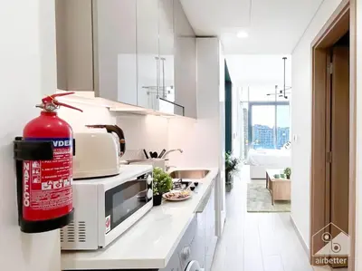 a kitchen with a fire extinguisher on the counter at Bright Studio in Azizi Riviera Perfect City Escape in Dubai