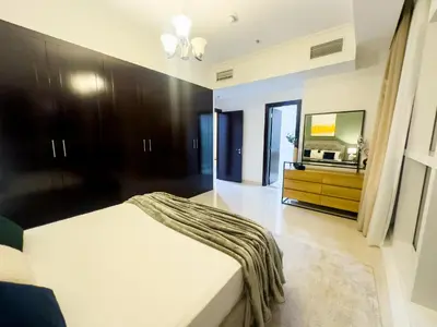 a bedroom with a bed and a flat screen tv at Luxury apartment in Business bay 5 people in Dubai