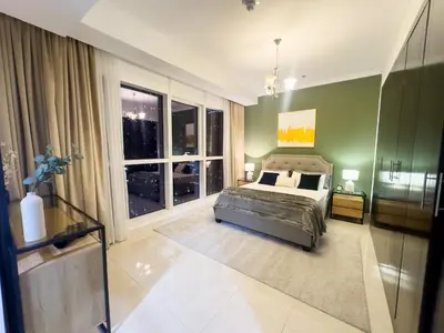 a bedroom with a bed and a large window at Luxury apartment in Business bay 5 people in Dubai