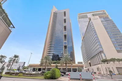 two tall buildings in a city with palm trees at Silkhaus Sky Gardens Chic Studio in DIFC Living in Dubai