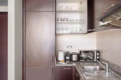 a kitchen with a sink and a counter at Silkhaus Comfort Studio at Sky gardens-DIFC in Dubai